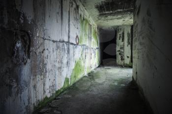 Empty abandoned bunker interior with black end of dark grungy corridor