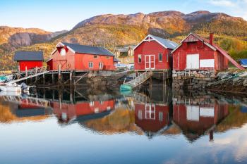 Traditional Norwegian red wooden barns stand on the sea coast. Snillfjord, Sor-Trondelag region, Vingvagen fishing village