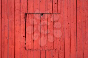 Old red wooden wall with closed square window, flat background photo texture