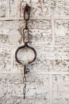 Medieval shackles mounted in old stone wall on Town Hall square in old Tallinn, Estonia