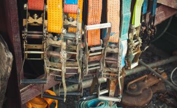 Colorful slings with steel buckles, vintage toned photo, old style effect