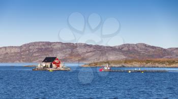 Norway, fish farm for salmon growing in natural environment. Norwegian Sea fjord in Trondheim region