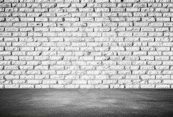 Empty abstract interior background with white brick wall and gray asphalt floor