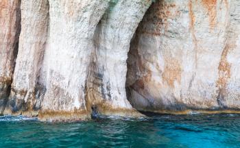 Blue cave, coastal rocks of Greek island Zakynthos with natural stone arches