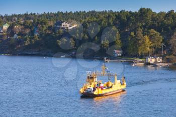 Yellow Ro-Ro cargo ship crossing the bay. Ferry line near Stockholm, Sweden