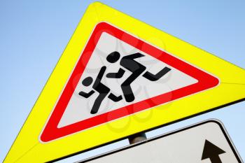 Caution children, Road sign in yellow frame over bright blue sky background