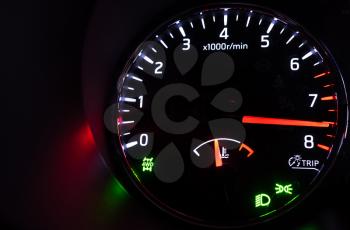 Closeup photo of modern car tachometer with hi speed on black background, night state