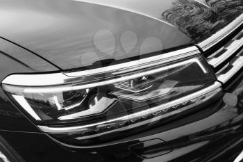 Modern shining car headlight with LED lamps, close-up photo with selective focus
