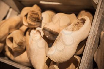 Defected clogs made of poplar wood. Klompen, traditional Dutch shoes for everyday use lay in wooden boxes