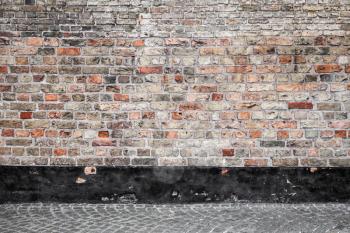 Abstract empty urban interior background with red brick wall and cobblestone street tiling