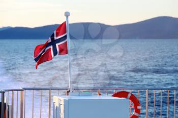 Flag of Norway mounted on stern railings of fast passenger ferry 