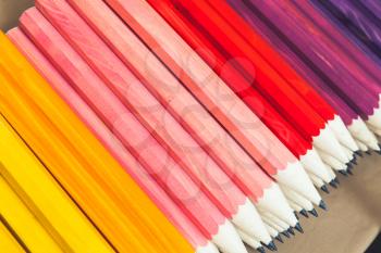 Stack of colorful graphite pencils, closeup photo, selective focus