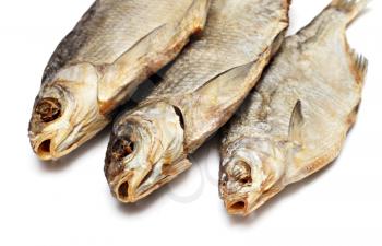 Three dried fishes isolated on white background