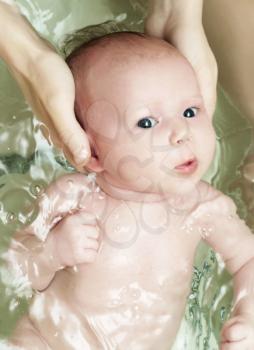 Newborn baby swim with mother care