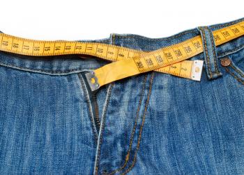 measuring tape around womans trousers