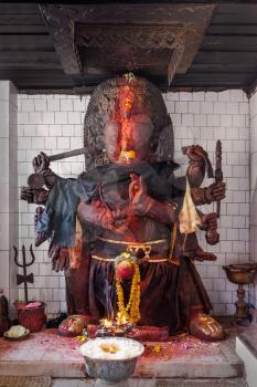 KATMANDU, NEPAL - APRIL 16: Terrible religious idol inside hindu temple at Durbar square on April 16, 2012, Katmandu, Nepal.