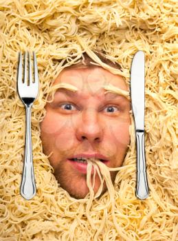 Man lying in pasta, dinner time