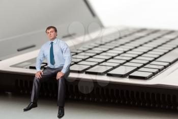 A man sitting on laptop thinks