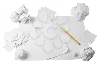 Workspace with crushed paper and pencil isolated on white