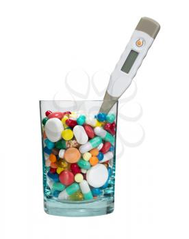 Medical cocktail - glass full of pills and thermometer. Isolated
