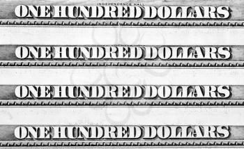 Row of one hundred dollars banknotes. Close-up view