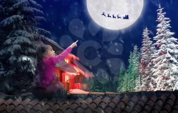 Girl sits on the roof in The Christmas eve pointing to the sky