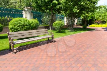 Bench in the park and brick path