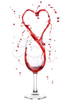 Red wine splashing from wineglass in heart shape