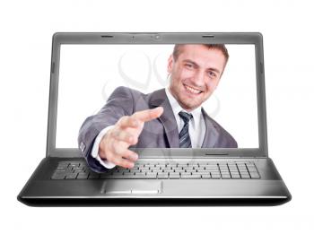 Smiling businessman is going to handshake from laptop. Isolated on white