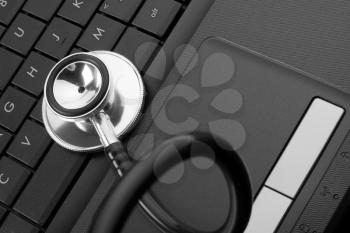 Medical stethoscope on laptop keyboard