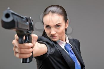 Young caucasian woman holding gun in her hand
