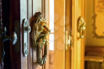 Close up of wooden doors with two metal knobs