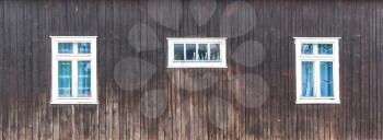 Old windows on rural wooden house