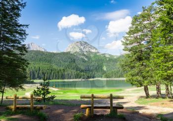 Nice view of mountain lake and wooden benches
