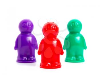 three small toy businessmans of the different colors