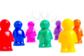 Crowd of the colorful toy people on white and a lot of copyspace on the top