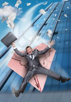 Scared businessman on paper airplane falling from business building