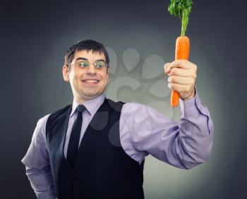 Carrot in hand of happy man