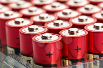 Many red AA batteries in a row
