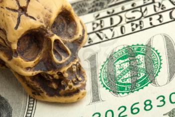 Bankruptcy concept. Human skull on money banknote
