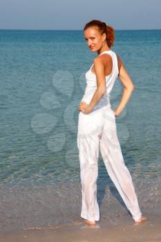 Tan woman in white on the beach