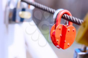 Close-up of heart shape padlock on bridge railing