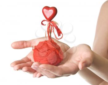 Hands with red ball of threads and heart