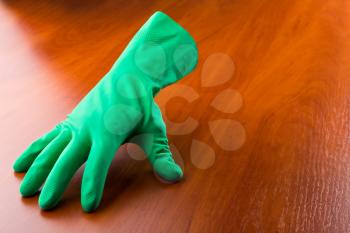 Green cleaning glove on the table