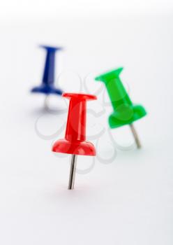 Three push-pins close-up isolated on white background