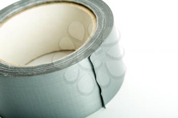 Roll of silver adhesive tape on white background
