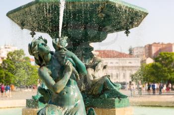 Refined fountain on the square with woman sculpture, Portugal