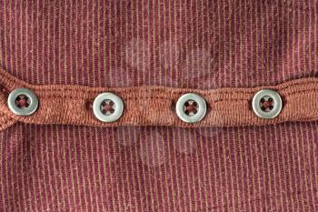 Brown jacket background with four buttons