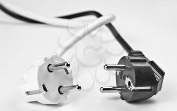 Concept of black and white. Two electrical plugs