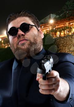 Mafia gangster pointing a gun to you